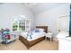 Cozy bedroom with a wood bed frame and plenty of natural light at 404 Brightling Way, Holly Springs, NC 27540