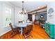 Inviting dining area featuring hardwood floors, ample natural light, and a cozy atmosphere for gatherings at 404 Brightling Way, Holly Springs, NC 27540