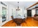 Charming dining area with hardwood floors, natural light, and a stylish table, ideal for Gathering meals at 404 Brightling Way, Holly Springs, NC 27540