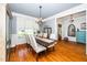 Elegant dining room with hardwood floors, crown molding, and a stylish chandelier at 404 Brightling Way, Holly Springs, NC 27540