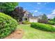 Beautiful two-story home featuring a well-manicured lawn, mature trees, and a two-car garage at 404 Brightling Way, Holly Springs, NC 27540