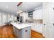 Spacious kitchen with an island, hardwood floors, stainless steel appliances, and ample cabinet space at 404 Brightling Way, Holly Springs, NC 27540