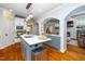 Well-designed kitchen with an island, modern appliances, and hardwood floors flowing into the inviting living room at 404 Brightling Way, Holly Springs, NC 27540
