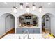 Elegant kitchen with white cabinetry, an island, and seamless flow into the living room, perfect for entertaining at 404 Brightling Way, Holly Springs, NC 27540