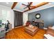 Stylish living room featuring exposed wood beams, hardwood floors and a custom bar area at 404 Brightling Way, Holly Springs, NC 27540