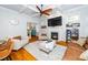 Bright living room with fireplace, hardwood floors, and comfortable seating arrangements for relaxing and entertaining at 404 Brightling Way, Holly Springs, NC 27540