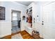 Mudroom entrance featuring custom storage bench with coat hooks and tiled floors at 404 Brightling Way, Holly Springs, NC 27540