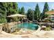Stunning pool with a rock waterfall feature, surrounded by lush greenery and complete with lounge chairs for relaxation at 404 Brightling Way, Holly Springs, NC 27540
