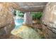Unique pool grotto featuring rock formations and a waterfall, creating a serene and private retreat at 404 Brightling Way, Holly Springs, NC 27540