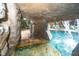 Pool grotto with waterfall feature and natural rock design, offering a secluded and tranquil swimming space at 404 Brightling Way, Holly Springs, NC 27540