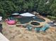 Aerial view of a luxurious pool area with a waterfall, spa, and ample seating, perfect for outdoor entertaining and relaxation at 404 Brightling Way, Holly Springs, NC 27540