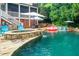 Outdoor pool area featuring a hot tub, lounge chairs, and lush landscaping for a relaxing backyard oasis at 404 Brightling Way, Holly Springs, NC 27540