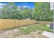 Spacious backyard with a wood fence, featuring some grass and dirt at 405 N Raiford St, Selma, NC 27576