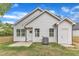 Exterior view of a white home showcasing the backyard and patio at 405 N Raiford St, Selma, NC 27576