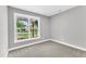 Cozy bedroom with gray walls and carpet, featuring a large window at 405 N Raiford St, Selma, NC 27576
