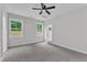 Spacious bedroom with ceiling fan, two windows and view to the outside, and ensuite bathroom at 405 N Raiford St, Selma, NC 27576