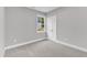 Bright bedroom features neutral walls, soft carpet, and a window view at 405 N Raiford St, Selma, NC 27576