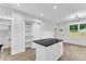 Bright kitchen featuring a kitchen island with black countertops and white cabinets at 405 N Raiford St, Selma, NC 27576