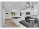 Modern kitchen with white cabinets, black countertops, stainless appliances, and open layout at 405 N Raiford St, Selma, NC 27576