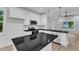 Modern kitchen featuring white cabinets, granite countertops, stainless appliances, and open floor plan at 405 N Raiford St, Selma, NC 27576