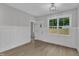 Charming living room with bright lighting, board and batten accents, and hardwood floors at 405 N Raiford St, Selma, NC 27576