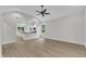 Spacious living room featuring vaulted ceilings, natural light, and seamless flow into the kitchen area at 405 N Raiford St, Selma, NC 27576