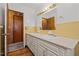 Bathroom featuring a double vanity, yellow tile backsplash, and wood-look flooring at 407 W Depot St, Angier, NC 27501