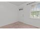 Bedroom featuring neutral carpet, a window, and a white door at 407 W Depot St, Angier, NC 27501