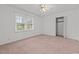 Cozy bedroom with carpeted floors, a ceiling fan, a window, and a closet at 407 W Depot St, Angier, NC 27501