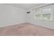 Bedroom with carpet, a window with blinds and white painted walls at 407 W Depot St, Angier, NC 27501