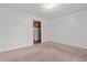 Cozy bedroom features neutral carpet, doorway leading to kitchen at 407 W Depot St, Angier, NC 27501