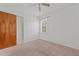 Bedroom featuring carpeted floors, a closet, a ceiling fan, and a window at 407 W Depot St, Angier, NC 27501