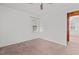 Bedroom with carpeted floors, a ceiling fan, a window, and paneled walls at 407 W Depot St, Angier, NC 27501