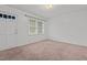 Bright bedroom featuring neutral carpet, a window, and fresh paint at 407 W Depot St, Angier, NC 27501