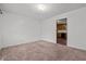 Spacious bedroom with neutral carpet and doorway leading to kitchen at 407 W Depot St, Angier, NC 27501