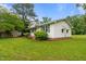 Exterior view of house shows white siding, brick foundation, and well-maintained lawn at 407 W Depot St, Angier, NC 27501