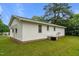 Exterior view of house shows white siding, brick foundation, and well-maintained lawn at 407 W Depot St, Angier, NC 27501