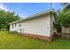 Exterior view of house shows white siding, brick foundation, and well-maintained lawn at 407 W Depot St, Angier, NC 27501