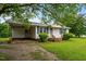 Traditional home with a cozy carport and a lush green lawn at 407 W Depot St, Angier, NC 27501