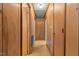 Wood-paneled hallway with carpeted floors, showcasing multiple doorways and storage at 407 W Depot St, Angier, NC 27501