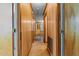 Hallway with wood-paneled walls, carpeted floors, and multiple doorways at 407 W Depot St, Angier, NC 27501