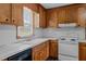 Traditional kitchen features wooden cabinets, a white countertop, and updated flooring at 407 W Depot St, Angier, NC 27501