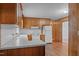 Traditional kitchen features wooden cabinets, a white countertop, and updated flooring at 407 W Depot St, Angier, NC 27501