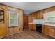Traditional kitchen features wooden cabinets, a white countertop, and updated flooring at 407 W Depot St, Angier, NC 27501