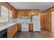 Traditional kitchen features wooden cabinets, a white countertop, and updated flooring at 407 W Depot St, Angier, NC 27501