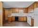 Traditional kitchen features wooden cabinets, a white countertop, and updated flooring at 407 W Depot St, Angier, NC 27501