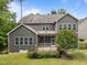 Exterior shot of house with the backyard, trees, and screened porch at 420 Creekhurst Pl, Cary, NC 27519