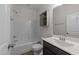 Well-lit bathroom with a shower/tub combo, stylish vanity with sink, and wood-look flooring, combining comfort and aesthetics at 420 Creekhurst Pl, Cary, NC 27519