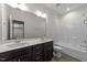 Elegant bathroom featuring a double vanity, a large mirror, and a shower/tub combo, exuding style and functionality at 420 Creekhurst Pl, Cary, NC 27519