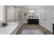 Spa-like bathroom featuring a soaking tub and a glass-enclosed shower at 420 Creekhurst Pl, Cary, NC 27519